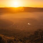 Sunrise over Ngorongoro Crater floor surrounded by volcanic caldera walls in Tanzania